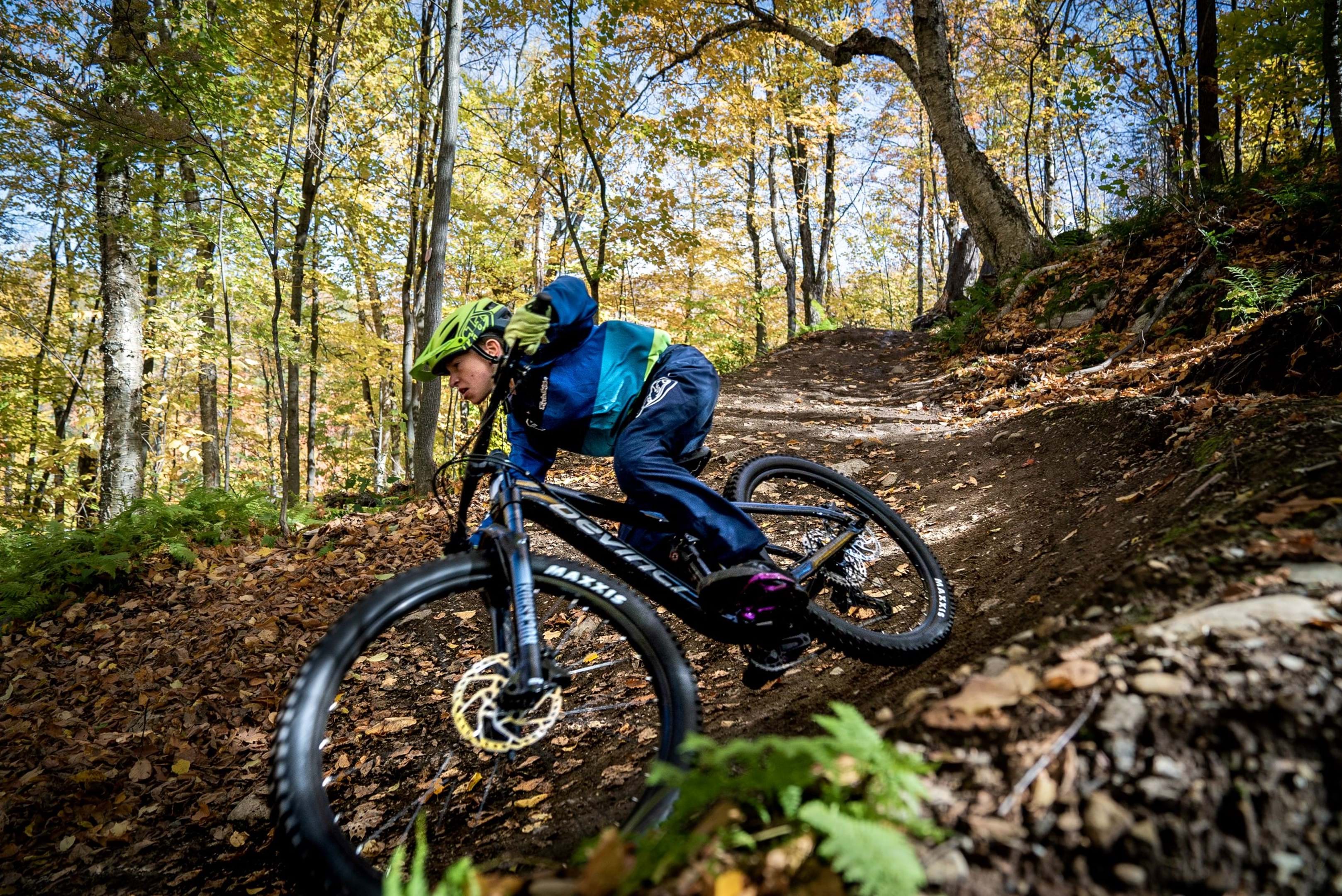 rider descending on a devinci marshall in a forest